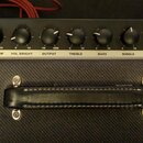 Černý kytarový zesilovač s bílým nápisem FENDER MUSICAL INSTRUMENTS vlevo a BASSBREAKER 45 vpravo. Horní panel obsahuje osm otočných knoflíků s popis…