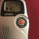 Stříbrný digitální metronom s černým rámem kolem displeje. Na spodní části je nápis MR-550 DIGITAL a pod displejem logo Matrix. Zařízení má pět ovlád…