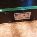 Zelený efektový pedalboard s nápisy VALETON a DAPPER BASS na horní hraně. Na spodní černé straně je bílá nálepka s textem EFFECTS STRIP, Adapter: 9V,…