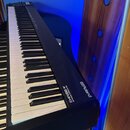Černý klavírní MIDI kontrolér s bílými a černými klávesami. Na horní části korpusu je bílý nápis „Roland“ s logem a vedle něj označení „MIDI KEYBOARD…