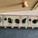 Detailní pohled na ovládací panel kytarového zesilovače v krémové barvě. Panel obsahuje nápisy CH 1, DRIVE, PUNCH, LEVEL, CH 2, DRIVE, GROWL, LEVEL,…