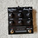 Černý kytarový předzesilovač s nápisy Hughes & Kettner a StompMan. Zařízení má šest otočných ovladačů s popisky MASTER, SAGGING, GAIN, PRESENCE, RESO…
