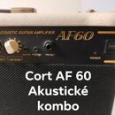 Detail ovládacího panelu akustického komba v černé barvě s bílým potahem skříně. Na panelu jsou nápisy ACOUSTIC GUITAR AMPLIFIER, AF60 a POWER, dva b…