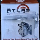 Krabice s příslušenstvím pro bicí s nápisy THE A.T.L.A.S MOUNT a logem Ludwig. Na obalu je text THE FIRST NAME IN DRUM HARDWARE, THE WORLD'S ONLY INT…