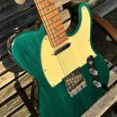 Elektrická kytara typu Telecaster s tmavě zeleným průsvitným lakem na dřevěném těle a krkem z jasného dřeva. Nástroj má béžový pickguard, jeden sníma…