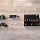 Černý efektový procesor s nápisem BOSS GT-1000CORE GUITAR EFFECTS PROCESSOR. Zařízení má digitální displej, několik ovládacích tlačítek a dva spodní…