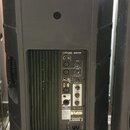 Zadní strana černého aktivního reproduktoru z plastu. Na ovládacím panelu je nápis Stagg SMS15P a různé vstupy a výstupy s popisky MIC 1 INPUT, LEVEL…