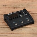 Černý kytarový procesor s nápisem FM3 AMP MODELER / FX PROCESSOR. Zařízení má digitální displej, ovládací knoflík a několik tlačítek s popisky HOME,…