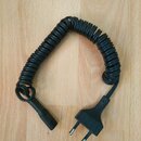 Černý spirálový napájecí kabel s kolenovou síťovou zástrčkou. Na plastovém krytu konektoru je vyražen nápis HARMONIKA. Povrch kabelu a plastů je v do…