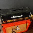 Černý kytarový kombozesilovač značky Marshall s bílým nápisem Marshall a označením JCM 900 50W HC Lead Dual Reverb. Přední panel obsahuje řadu ovláda…