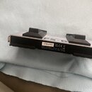 Fotografie zachycuje stříbrný kovový modul s černými plastovými prvky. Na horní části je nápis FS-6 a text DUAL SWITCH CH. Štítek na boku obsahuje kó…