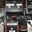 Černý kytarový spínací pedál s červeným rámem a nápisy CLEAN/CRUNCH a LEAD LO/HI. V horní části je bílé logo Marshall a označení PEDL-90012. Pod ním…