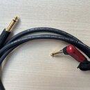 Černý kabel s konektory typu 6,3 mm jack. Na kabelu je bílý nápis SC- SPIRIT LLX • Highflex Low Loss • [OFC] 1 x 0,38mm² (AWG21) Advanced Guitar Cabl…