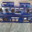 Modrý looper JamMan od značky DigiTech. Na horní části jsou ovládací knoflíky, tlačítka a malý displej s nápisy PLAY, RECORD, LEVEL, SELECT a LOOP. Z…