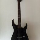 Černá elektrická kytara s tmavým hnedým hmatníkem a stříbrným hardwarem. Na 12. pražci je viditelný nápis "Fender". Tělo kytary má lesklý povrch s ně…