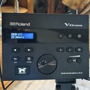 Černý elektronický modul s nápisy Roland a V-Drums. Na displeji je text DRUM KIT 29 Nebula. V pravém dolním rohu je uveden model DRUM SOUND MODULE TD…