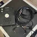 Černý bicí modul značky ALESIS s nápisem FORGE a označením ADVANCED DRUM MODULE. Zařízení obsahuje displej, ovládací knoflíky, centrální volič a řadu…