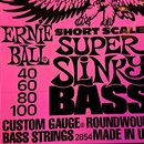 Detailní pohled na růžové obalové sáčky basových strun. Na obalu je černý nápis ERNIE BALL, SHORT SCALE SUPER SLINKY BASS a čísla 40, 60, 80, 100. Do…