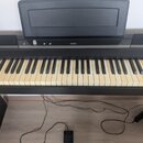 Černý digitální piano s klávesnicí. Na horním panelu je bílý nápis KORG a vpravo označení modelu SP-170S. Nástroj stojí na černém stojanu a k němu ve…