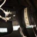 Detailní pohled na zadní část černého reproduktoru s připojenými bílými vodiči. Na bílé štítku je uveden text 10771104, 12925, 67-94488551, 8 OHM a G…