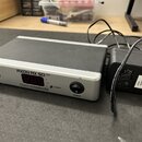 Stříbrno-černý externí zvukový interface s nápisem AXON RX 50 USB a logem TERRATEC PRODUCER. Zařízení má na přední straně vstup INPUT, červený digitá…