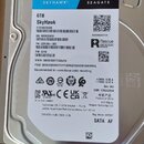 Fotografie znázorňuje pevný disk značky SEAGATE z řady SkyHawk o kapacitě 6TB. Na štítku je uveden model ST6000VX009, sériové číslo SN: WVX0EAR0 a PN…