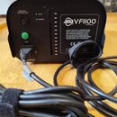 Černý kouřový stroj s nápisem ADJ VF1100 a webovou adresou www.adj.com. Na předním panelu jsou kontrolky READY a HEATING, zelené tlačítko FOG a nápis…