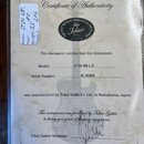Fotografie znázorňuje certifikát pravosti (Certificate of Authenticity) s logem Tokai. Dokument obsahuje texty „Model: ST50 BB L.E.“ a „Serial Number…