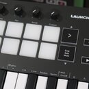 Detailní pohled na černý MIDI kontrolér s bílými klávesami a bílými čtvercovými pady. Na horní části je nápis LAUNCHKEY MINI s doprovodným logem. Jso…