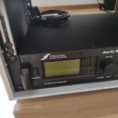 Černý rackový procesor s nápisem FRACTAL AUDIO SYSTEMS a označením Axe-Fx II. Zařízení má v přední části displej, zapínací tlačítko POWER a ovládací…