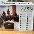 Kartonová krabice s kytarovým kombem Blackstar ID:CORE BEAM Bluetooth Amplifier. Na obalu jsou fotografie hudebníků s nástroji a seznam technických p…