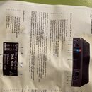 Fotografie zachycuje uživatelský manuál k bezdrátovému systému. Na stránce je vidět černý vysílač s nápisem SENNHEISER a schéma ovládacích prvků. Dis…