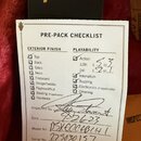Fotografie zobrazuje papírový kontrolní seznam s nadpisem PRE-PACK CHECKLIST. Dokument obsahuje zaškrtnuté položky v sekcích EXTERIOR FINISH a PLAYAB…