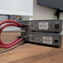 Dvě stříbrná audio zařízení značky SCHIIT v kovovém provedení, umístěná nad sebou. Horní zařízení má nápis MADE IN USA a štítek s označením SCH07A, s…