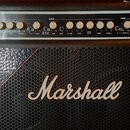 Černý kytarový kombo zesilovač značky Marshall. Horní ovládací panel obsahuje bílé ovratové knoflíky a nápisy jako MBB series 6010, MODERN, CLASSIC,…