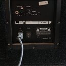 Zadní panel černého reproduktoru s ovládacími prvky. Jsou zde nápisy INPUT 0dB, VOLUME, SHIELD, ON, LEM a H 350A. V dolní části jsou popisky AC~, POW…