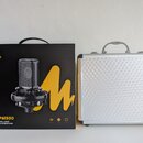 Fotografie zobrazuje černou originální krabici s mikrofonem a stříbrný hliníkový kufřík. Na krabici je logo maono, označení modelu AU-PM500 a nápis P…