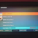Fotografie zachycuje displej zařízení s otevřeným menu EXPANSION. V seznamu jsou uvedeny položky EXM001: JUPITER-8, EXM002: JUNO-106, EXSN01: SN Ac.P…