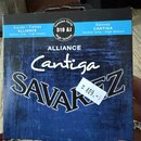 Fotografie znázorňuje modré papírové balení strun. Na obalu jsou nápisy ALLIANCE, Cantiga a SAVAREZ. V horní části je uveden text Aiguës / Trebles AL…