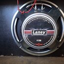 Fotografie zachycuje reproduktor s černým papírovým kónem a stříbrným kovovým rámem. Uprostřed je štít s logem Laney a nápisy CLASSIC BRITISH AMPLIFI…