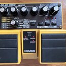 Žlutý kytarový pedál s názvy OD-20 OVERDRIVE/DISTORTION, COSM a Drive ZONE. Horní panel obsahuje pět ovládacích knoflíků, několik tlačítek a tabulku…