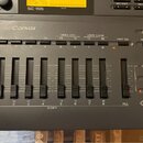 Černý MIDI modul s nápisem SoundCanvas a označením SC-155. Přístroj obsahuje řadu tlačítek s popisky jako MINUS ONE, USER CLEAR a PART SEL, dále osm…
