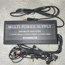 Černý napájecí adaptér s nápisem MULTI POWER SUPPLY, SEPARATE ISOLATED a STARBUCK. Pod názvem je uveden text 1 x 9V DC/500mA + 1 x 9V DC/300mA + 6 x…