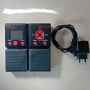 Černý digitální efektový pedál značky ZOOM s červenými detaily a šedým displejem. Na zařízení jsou nápisy B1on, HOME, ENTER, MENU a RHYTHM / LOOPER.…