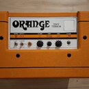 Kytarový zesilovač v oranžovém texturovaném potahu s černými rohovými chrániči. Na horním bílém panelu je nápis ORANGE a model TINY TERROR. Ovládací…