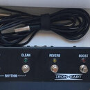 Černý kytarový spínací pedál s четыřmi stoupacími spínači a kontrolkami. Nad spínači jsou bílé nápisy LEAD, CLEAN, REVERB a BOOST, v dolní části je n…