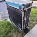 Černý transportní case na kolečkách s modrým horním víkem a hliníkovými hranami. Na boku jsou viditelné nápisy „DiGiCo“, „SOS“ a stylizovaný nápis „S…