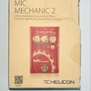 Fotografie znázorňuje kartonové balení efektového pedálu. Na krabici je nápis MIC MECHANIC 2 a text Ultra-Simple Battery-Powered Vocal Effects Stompb…