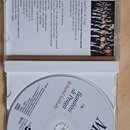 Fotografie znázorňuje otevřené CD v plastovém obalu. Na discu je nápis „Moravské koledy“, „Bambini di Praga“, „Bohumil Kalínský“, „Hradistian“ a „Jiř…