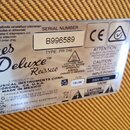 Detailní fotografie stříbrného typového štítku na zadní straně zesilovače. Na štítku je nápis Blues Deluxe Reissue, značka FENDER MUSICAL INSTRUMENTS…